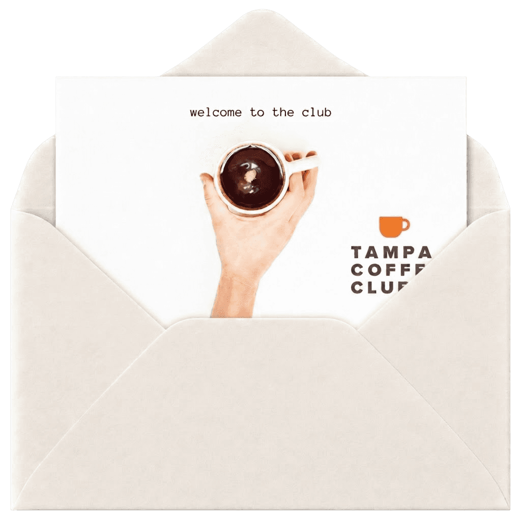 A handwritten welcome card tucked in an opened envelope, reading “welcome to the club”.